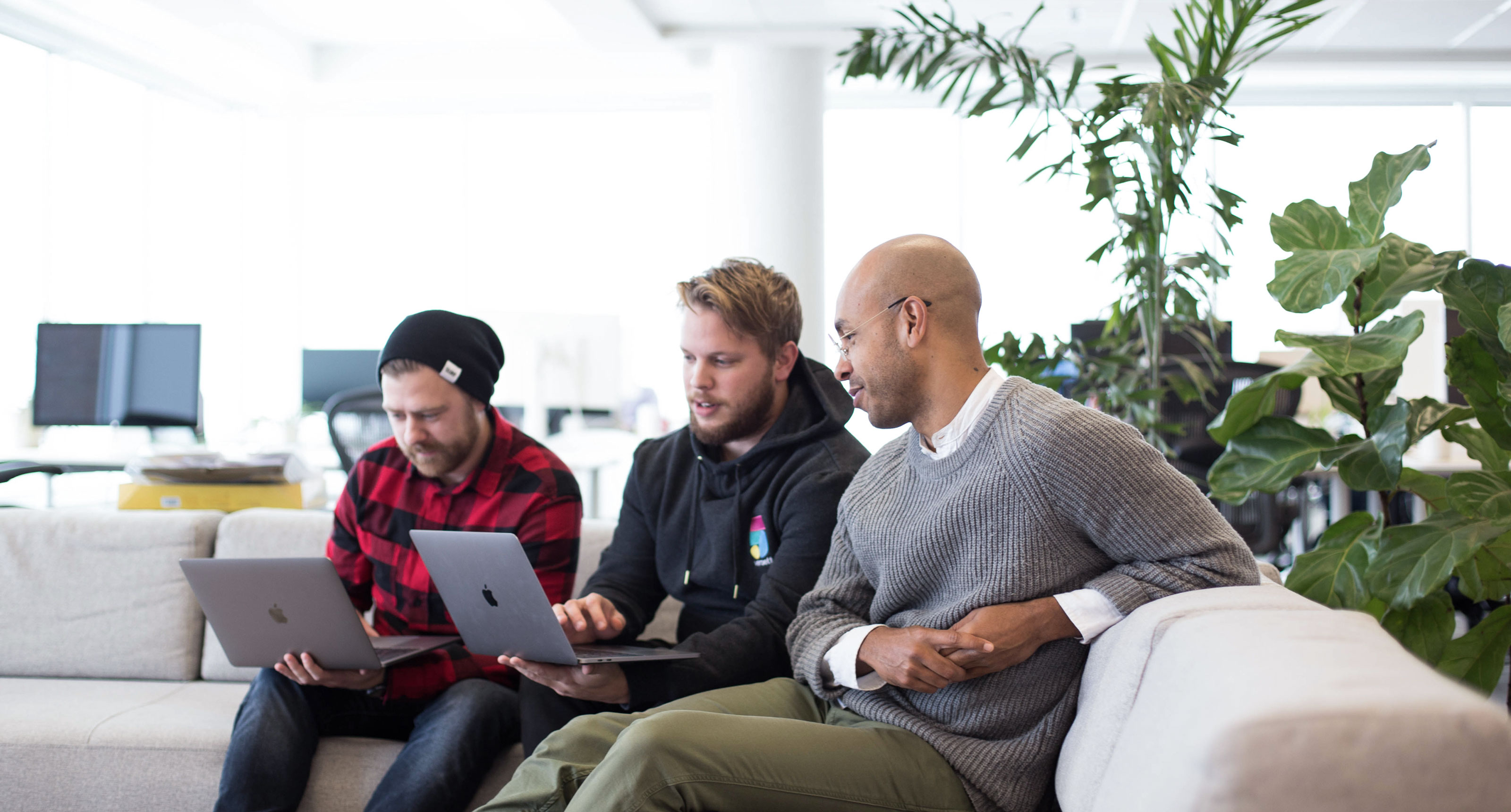 People collaborating on the couch.